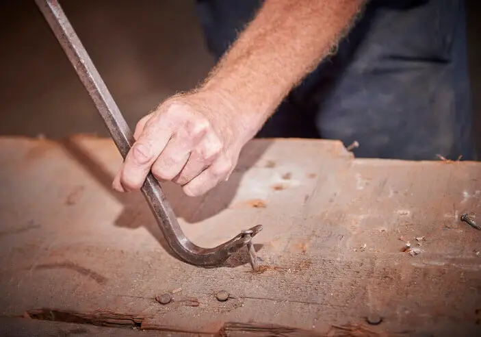 remove nails with cat’s paw pry bar