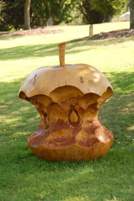 a half eaten apple chainsaw carving