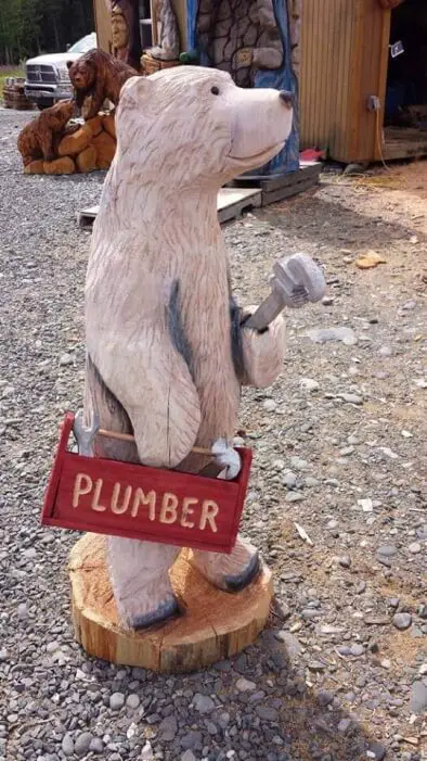 Plumber Bear chainsaw carving